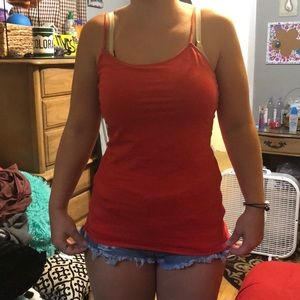 A salmon colored spaghetti strap tank top